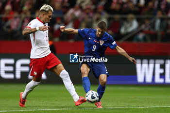 2024-10-15 - Kamil Piatkowski of Poland and Andrej Kramaric of Croatia during the UEFA Nations League, League A, Group A1 football match between Poland and Croatia on 15 October 2024 at PGE Narodowy stadium in Warsaw, Poland - FOOTBALL - UEFA NATIONS LEAGUE - POLAND V CROATIA - UEFA NATIONS LEAGUE - SOCCER