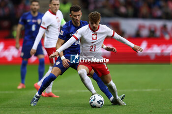 2024-10-15 - Ivan Perisic of Croatia and Nicola Zalewski of Poland during the UEFA Nations League, League A, Group A1 football match between Poland and Croatia on 15 October 2024 at PGE Narodowy stadium in Warsaw, Poland - FOOTBALL - UEFA NATIONS LEAGUE - POLAND V CROATIA - UEFA NATIONS LEAGUE - SOCCER