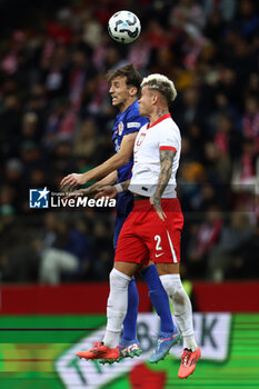 2024-10-15 - Ante Budimir of Croatia and Kamil Piatkowski of Poland during the UEFA Nations League, League A, Group A1 football match between Poland and Croatia on 15 October 2024 at PGE Narodowy stadium in Warsaw, Poland - FOOTBALL - UEFA NATIONS LEAGUE - POLAND V CROATIA - UEFA NATIONS LEAGUE - SOCCER