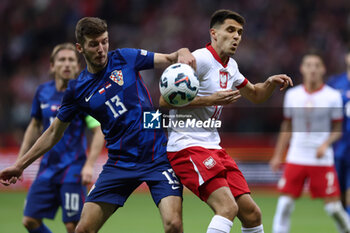 2024-10-15 - Petar Sucic of Croatia and Bartosz Kapustka of Poland during the UEFA Nations League, League A, Group A1 football match between Poland and Croatia on 15 October 2024 at PGE Narodowy stadium in Warsaw, Poland - FOOTBALL - UEFA NATIONS LEAGUE - POLAND V CROATIA - UEFA NATIONS LEAGUE - SOCCER