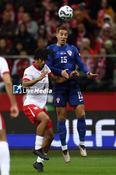 2024-10-15 - Maximillian Oyedele of Poland and Mario Pasalic of Croatia during the UEFA Nations League, League A, Group A1 football match between Poland and Croatia on 15 October 2024 at PGE Narodowy stadium in Warsaw, Poland - FOOTBALL - UEFA NATIONS LEAGUE - POLAND V CROATIA - UEFA NATIONS LEAGUE - SOCCER