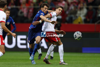 2024-10-15 - Ante Budimir of Croatia and Jan Bednarek of Poland during the UEFA Nations League, League A, Group A1 football match between Poland and Croatia on 15 October 2024 at PGE Narodowy stadium in Warsaw, Poland - FOOTBALL - UEFA NATIONS LEAGUE - POLAND V CROATIA - UEFA NATIONS LEAGUE - SOCCER