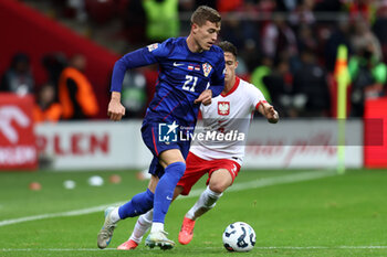 2024-10-15 - Luka Sucic of Croatia and Kacper Urbanski of Poland during the UEFA Nations League, League A, Group A1 football match between Poland and Croatia on 15 October 2024 at PGE Narodowy stadium in Warsaw, Poland - FOOTBALL - UEFA NATIONS LEAGUE - POLAND V CROATIA - UEFA NATIONS LEAGUE - SOCCER