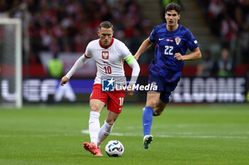 2024-10-15 - Piotr Zielinski of Poland and Igor Matanovic of Croatia during the UEFA Nations League, League A, Group A1 football match between Poland and Croatia on 15 October 2024 at PGE Narodowy stadium in Warsaw, Poland - FOOTBALL - UEFA NATIONS LEAGUE - POLAND V CROATIA - UEFA NATIONS LEAGUE - SOCCER