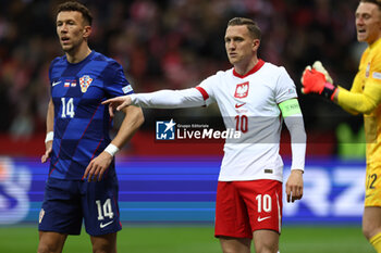 2024-10-15 - Ivan Perisic of Croatia and Piotr Zielinski of Poland during the UEFA Nations League, League A, Group A1 football match between Poland and Croatia on 15 October 2024 at PGE Narodowy stadium in Warsaw, Poland - FOOTBALL - UEFA NATIONS LEAGUE - POLAND V CROATIA - UEFA NATIONS LEAGUE - SOCCER