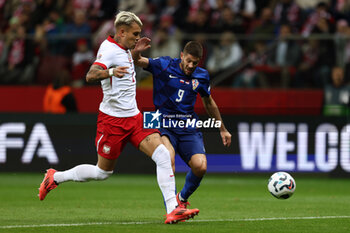 2024-10-15 - Kamil Piatkowski of Poland and Andrej Kramaric of Croatia during the UEFA Nations League, League A, Group A1 football match between Poland and Croatia on 15 October 2024 at PGE Narodowy stadium in Warsaw, Poland - FOOTBALL - UEFA NATIONS LEAGUE - POLAND V CROATIA - UEFA NATIONS LEAGUE - SOCCER