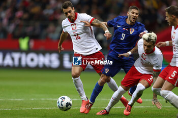 2024-10-15 - Jakub Kiwior, Kamil Piatkowski of Poland and Andrej Kramaric of Croatia during the UEFA Nations League, League A, Group A1 football match between Poland and Croatia on 15 October 2024 at PGE Narodowy stadium in Warsaw, Poland - FOOTBALL - UEFA NATIONS LEAGUE - POLAND V CROATIA - UEFA NATIONS LEAGUE - SOCCER