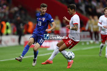 2024-10-15 - Petar Sucic of Croatia and Jakub Kiwior of Poland during the UEFA Nations League, League A, Group A1 football match between Poland and Croatia on 15 October 2024 at PGE Narodowy stadium in Warsaw, Poland - FOOTBALL - UEFA NATIONS LEAGUE - POLAND V CROATIA - UEFA NATIONS LEAGUE - SOCCER