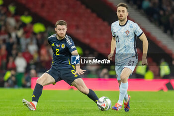 15/10/2024 - Anthony Ralston of Scotland and Diogo Jota of Portugal during the UEFA Nations League, League A, Group A1 football match between Scotland and Portugal on 15 October 2024 at Hampden Park in Glasgow, Scotland - FOOTBALL - UEFA NATIONS LEAGUE - SCOTLAND V PORTUGAL - UEFA NATIONS LEAGUE - CALCIO