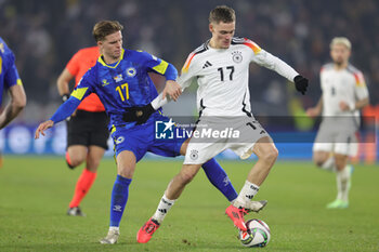 2024-11-16 - Florian Wirtz of Germany and Dzenis Burnic of Bosnia Herzegovina during the UEFA Nations League, League phase, Matchday 5 football match between Germany and Bosnia Herzegovina on 16 November 2024 at Europa-Park Stadion in Freiburg, Germany - FOOTBALL - UEFA NATIONS LEAGUE - GERMANY V BOSNIA HERZEGOVINA - UEFA NATIONS LEAGUE - SOCCER