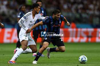 2024-08-14 - Jude Bellingham of Real Madrid and Sead Kolasinac of Atalanta during the UEFA Super Cup 2024 football match between Real Madrid CF and Atalanta BC on 14 August 2024 at PGE Narodowy in Warsaw, Poland - FOOTBALL - UEFA SUPER CUP 2024 - REAL MADRID V ATALANTA - UEFA SUPER CUP - SOCCER