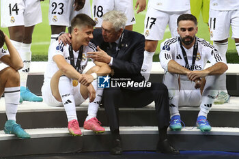 2024-08-14 - Arda Guler, Carlo Ancelotti, Dani Carvajal of Real Madrid during the UEFA Super Cup 2024 football match between Real Madrid CF and Atalanta BC on 14 August 2024 at PGE Narodowy in Warsaw, Poland - FOOTBALL - UEFA SUPER CUP 2024 - REAL MADRID V ATALANTA - UEFA SUPER CUP - SOCCER