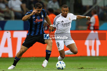 2024-08-14 - Sead Kolasinac of Atalanta and Kylian Mbappe of Real Madrid during the UEFA Super Cup 2024 football match between Real Madrid CF and Atalanta BC on 14 August 2024 at PGE Narodowy in Warsaw, Poland - FOOTBALL - UEFA SUPER CUP 2024 - REAL MADRID V ATALANTA - UEFA SUPER CUP - SOCCER