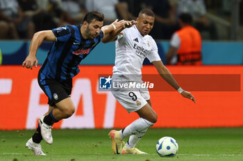 2024-08-14 - Sead Kolasinac of Atalanta and Kylian Mbappe of Real Madrid during the UEFA Super Cup 2024 football match between Real Madrid CF and Atalanta BC on 14 August 2024 at PGE Narodowy in Warsaw, Poland - FOOTBALL - UEFA SUPER CUP 2024 - REAL MADRID V ATALANTA - UEFA SUPER CUP - SOCCER