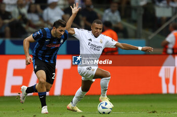 2024-08-14 - Sead Kolasinac of Atalanta and Kylian Mbappe of Real Madrid during the UEFA Super Cup 2024 football match between Real Madrid CF and Atalanta BC on 14 August 2024 at PGE Narodowy in Warsaw, Poland - FOOTBALL - UEFA SUPER CUP 2024 - REAL MADRID V ATALANTA - UEFA SUPER CUP - SOCCER