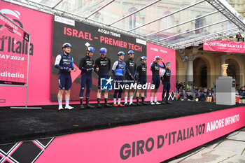 07/05/2024 - Israel Premier Tech on the signature podium Tappa 4 - Acqui Terme-Andora - Giro d'Italia 2024 - STAGE 4 - AQUI TERME-ANDORA - GIRO D'ITALIA - CICLISMO