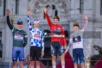 2024-09-08 - Primoz Roglic (CR) of Slovenia and Team Red Bull Bora - Hansgrohe celebrates his victory on the podium with (from L to R) Kaden Groves of Australia and Team Alpecin Deceuninck, Jay Vine of Australia and UAE Team Emirates and Enric Mas of Spain and Team Movistar at the end of the 79th Tour of Spain 2024 - Stage 21 on September 8, 2024 in Madrid, Spain. - LA VUELTA 2024: ETAPA 21 - SPANISH LA VUELTA - CYCLING