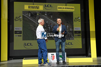 2024-06-29 - the mayor of Rimini Jamil Sadegholvaad intervew on the podium of the tour de France 2024 during first stage - STAGE 1 - FINISH - TOUR DE FRANCE - CYCLING