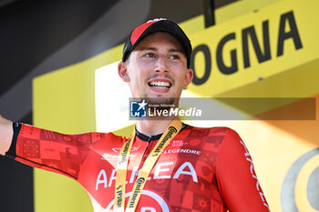 2024-06-30 - VAUQUELIN Kevin (team Arkea) celebrating on the podium his victory of the second stage of the Tour de France 2024 in Bologna (italy) - STAGE 2 - FINISH - TOUR DE FRANCE - CYCLING