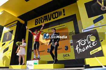 2024-06-30 - VAUQUELIN Kevin (team Arkea) celebrating on the podium the victory of the second stage of the Tour de France 2024 in Bologna (italy) - STAGE 2 - FINISH - TOUR DE FRANCE - CYCLING