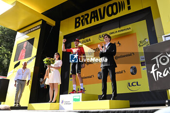 2024-06-30 - VAUQUELIN Kevin (team Arkea) celebrating on the podium the victory of the second stage of the Tour de France 2024 in Bologna (italy) - STAGE 2 - FINISH - TOUR DE FRANCE - CYCLING