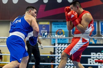 2024-03-06 - Toktosun Uulu Bakyt (Kgz) in red and Lenzi Diego (Ita) in blue during the Boxing Road to Paris 1st World Qualification Tournament, at E-Work Arena, Busto Arsizio, Italy on March 6, 2024 - BOXING ROAD TO PARIS - BOXING - CONTACT