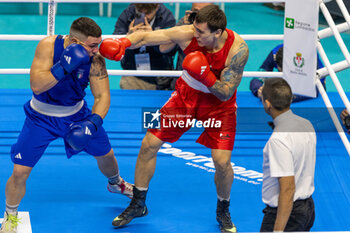 11/03/2024 - Latypov Danis (Brn) in red and Lenzi Diego (Ita) in blue during the Boxing Road to Paris 1st World Qualification Tournament, at E-Work Arena, Busto Arsizio, Italy on March 11, 2024 - BOXING ROAD TO PARIS - BOXE - CONTATTO