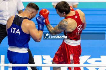 11/03/2024 - Latypov Danis (Brn) in red and Lenzi Diego (Ita) in blue during the Boxing Road to Paris 1st World Qualification Tournament, at E-Work Arena, Busto Arsizio, Italy on March 11, 2024 - BOXING ROAD TO PARIS - BOXE - CONTATTO