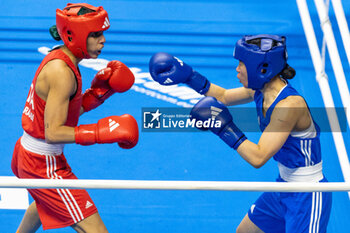 2024-03-11 - Charaabi Sirine (Ita) in red and Im Aeji (Kor) in blue during the Boxing Road to Paris 1st World Qualification Tournament, at E-Work Arena, Busto Arsizio, Italy on March 11, 2024 - BOXING ROAD TO PARIS - BOXING - CONTACT