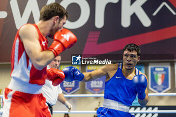 2024-03-11 - Odajev Saparmyrat (Tkm) in red and Cova Jesus (Ven) in blue during the Boxing Road to Paris 1st World Qualification Tournament, at E-Work Arena, Busto Arsizio, Italy on March 11, 2024 - BOXING ROAD TO PARIS - BOXING - CONTACT