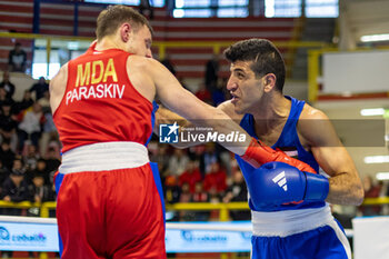2024-03-11 - Paraschiv Alexandru (Mda) in red and Alkasbeh Obada (Jor) in blue during the Boxing Road to Paris 1st World Qualification Tournament, at E-Work Arena, Busto Arsizio, Italy on March 11, 2024 - BOXING ROAD TO PARIS - BOXING - CONTACT