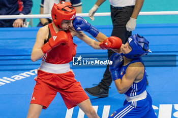2024-03-11 - Jedinakova Miroslava (Svk) in red and Mesiano Alessia (Ita) in blue during the Boxing Road to Paris 1st World Qualification Tournament, at E-Work Arena, Busto Arsizio, Italy on March 11, 2024 - BOXING ROAD TO PARIS - BOXING - CONTACT