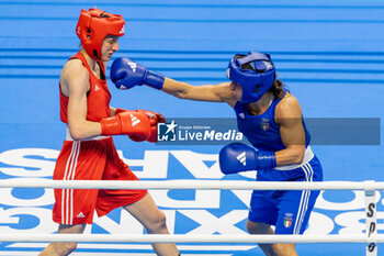 11/03/2024 - Jedinakova Miroslava (Svk) in red and Mesiano Alessia (Ita) in blue during the Boxing Road to Paris 1st World Qualification Tournament, at E-Work Arena, Busto Arsizio, Italy on March 11, 2024 - BOXING ROAD TO PARIS - BOXE - CONTATTO