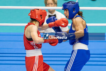 2024-03-11 - Jedinakova Miroslava (Svk) in red and Mesiano Alessia (Ita) in blue during the Boxing Road to Paris 1st World Qualification Tournament, at E-Work Arena, Busto Arsizio, Italy on March 11, 2024 - BOXING ROAD TO PARIS - BOXING - CONTACT