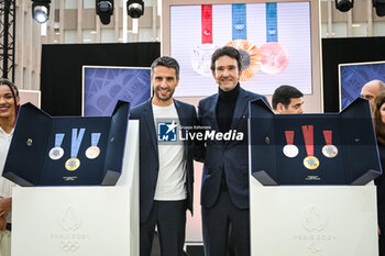2024-02-08 - President of the Paris 2024 Organising Committee for the Olympic and Paralympic Games and former French canoeist Tony ESTANGUET and CEO of LVMH Holding Company Antoine ARNAULT pose next to Olympic and Paralympic medals during the unveiling of the medals for the Paris 2024 Olympic and Paralympic games on February 8, 2024 in Saint-Denis, France - OLYMPIC GAMES PARIS 2024 - UNVEILING OF OLYMPIC AND PARALYMPIC MEDALS - OLYMPIC GAMES PARIS 2024 - OLYMPIC GAMES