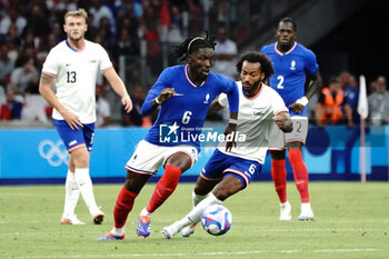 2024-07-24 - Manu Koné (France) and Gianluca Busio (USA) during the Football, Men's Group A, between France and United States during the Olympic Games Paris 2024 on 24 July 2024 at Geoffroy-Guichard Stadium in Marseille, France - OLYMPIC GAMES PARIS 2024 - 24/07 - OLYMPIC GAMES PARIS 2024 - OLYMPIC GAMES