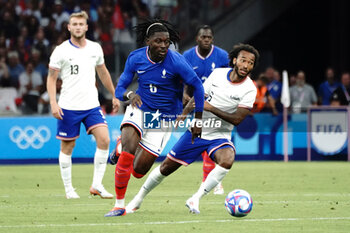 2024-07-24 - Manu Koné (France) and Gianluca Busio (USA) during the Football, Men's Group A, between France and United States during the Olympic Games Paris 2024 on 24 July 2024 at Geoffroy-Guichard Stadium in Marseille, France - OLYMPIC GAMES PARIS 2024 - 24/07 - OLYMPIC GAMES PARIS 2024 - OLYMPIC GAMES