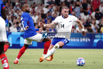 2024-07-24 - Alexandre Lacazette (France) and Djordje Mihailovic (USA) during the Football, Men's Group A, between France and United States during the Olympic Games Paris 2024 on 24 July 2024 at Geoffroy-Guichard Stadium in Marseille, France - OLYMPIC GAMES PARIS 2024 - 24/07 - OLYMPIC GAMES PARIS 2024 - OLYMPIC GAMES