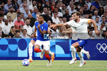 2024-07-24 - Michael Olise (France) and Tanner Tessmann (USA) during the Football, Men's Group A, between France and United States during the Olympic Games Paris 2024 on 24 July 2024 at Geoffroy-Guichard Stadium in Marseille, France - OLYMPIC GAMES PARIS 2024 - 24/07 - OLYMPIC GAMES PARIS 2024 - OLYMPIC GAMES