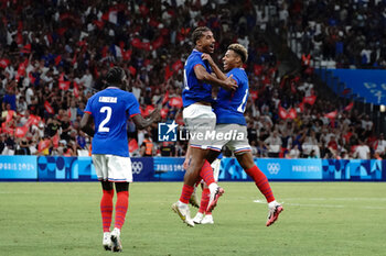 2024-07-24 - Loïc Badé (France) celebrates his goal with Désiré Doué (France) and Castello Lukeba (France) during the Football, Men's Group A, between France and United States during the Olympic Games Paris 2024 on 24 July 2024 at Geoffroy-Guichard Stadium in Marseille, France - OLYMPIC GAMES PARIS 2024 - 24/07 - OLYMPIC GAMES PARIS 2024 - OLYMPIC GAMES