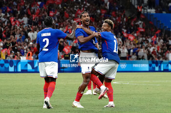 2024-07-24 - Loïc Badé (France) celebrates his goal with Désiré Doué (France) and Castello Lukeba (France) during the Football, Men's Group A, between France and United States during the Olympic Games Paris 2024 on 24 July 2024 at Geoffroy-Guichard Stadium in Marseille, France - OLYMPIC GAMES PARIS 2024 - 24/07 - OLYMPIC GAMES PARIS 2024 - OLYMPIC GAMES