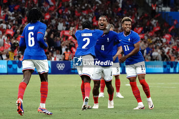 2024-07-24 - Loïc Badé (France) celebrates his goal with Désiré Doué (France) and Castello Lukeba (France) during the Football, Men's Group A, between France and United States during the Olympic Games Paris 2024 on 24 July 2024 at Geoffroy-Guichard Stadium in Marseille, France - OLYMPIC GAMES PARIS 2024 - 24/07 - OLYMPIC GAMES PARIS 2024 - OLYMPIC GAMES