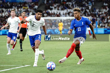 2024-07-24 - Nathan Harriel (USA) and Désiré Doué (France) during the Football, Men's Group A, between France and United States during the Olympic Games Paris 2024 on 24 July 2024 at Velodrome Stadium in Marseille, France - OLYMPIC GAMES PARIS 2024 - 24/07 - OLYMPIC GAMES PARIS 2024 - OLYMPIC GAMES