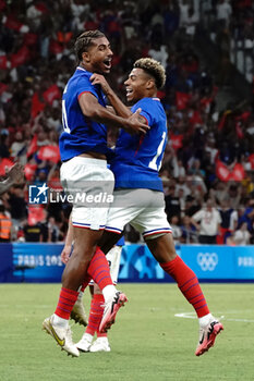 2024-07-24 - Loïc Badé (France) celebrates his goal with Désiré Doué during the Football, Men's Group A, between France and United States during the Olympic Games Paris 2024 on 24 July 2024 at Velodrome Stadium in Marseille, France - OLYMPIC GAMES PARIS 2024 - 24/07 - OLYMPIC GAMES PARIS 2024 - OLYMPIC GAMES