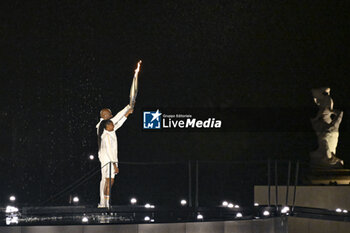 2024-07-26 - Teddy Riner and Marie-José Pérec light the Olympic cauldron, Opening Ceremony during the Olympic Games Paris 2024 on 26 July 2024 in Paris, France - OLYMPIC GAMES PARIS 2024 - OPENING CEREMONY - 26/07 - OLYMPIC GAMES PARIS 2024 - OLYMPIC GAMES