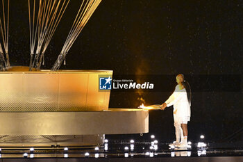 2024-07-26 - Teddy Riner and Marie-José Pérec light the Olympic cauldron, Opening Ceremony during the Olympic Games Paris 2024 on 26 July 2024 in Paris, France - OLYMPIC GAMES PARIS 2024 - OPENING CEREMONY - 26/07 - OLYMPIC GAMES PARIS 2024 - OLYMPIC GAMES