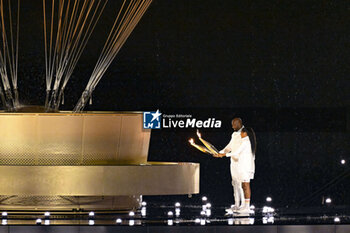 2024-07-26 - Teddy Riner and Marie-José Pérec light the Olympic cauldron, Opening Ceremony during the Olympic Games Paris 2024 on 26 July 2024 in Paris, France - OLYMPIC GAMES PARIS 2024 - OPENING CEREMONY - 26/07 - OLYMPIC GAMES PARIS 2024 - OLYMPIC GAMES