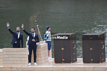 2024-07-26 - Martin Fourcade and Michael Phelps, Louis Vuitton Torches trunks protecting the Olympic and Paralympic flames of Paris 2024, Opening Ceremony during the Olympic Games Paris 2024 on 26 July 2024 in Paris, France - OLYMPIC GAMES PARIS 2024 - OPENING CEREMONY - 26/07 - OLYMPIC GAMES PARIS 2024 - OLYMPIC GAMES