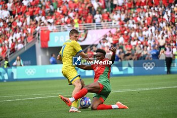 2024-07-27 - Oleg Ocheretko (Ukraine) and Akram Nakach (Morocco), Football, Men's Group B between Ukraine and Morocco during the Olympic Games Paris 2024 on 27 July 2024 at Geoffroy-Guichard Stadium in Saint-Etienne, France - OLYMPIC GAMES PARIS 2024 - 27/07 - OLYMPIC GAMES PARIS 2024 - OLYMPIC GAMES