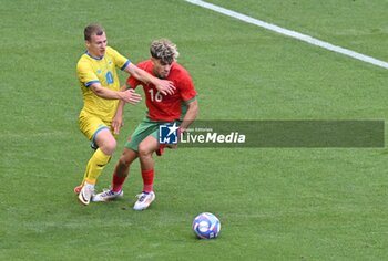 2024-07-27 - Maksym Braharu (Ukraine) and Abde Ezzalzouli (Morocco), Football, Men's Group B between Ukraine and Morocco during the Olympic Games Paris 2024 on 27 July 2024 at Geoffroy-Guichard Stadium in Saint-Etienne, France - OLYMPIC GAMES PARIS 2024 - 27/07 - OLYMPIC GAMES PARIS 2024 - OLYMPIC GAMES